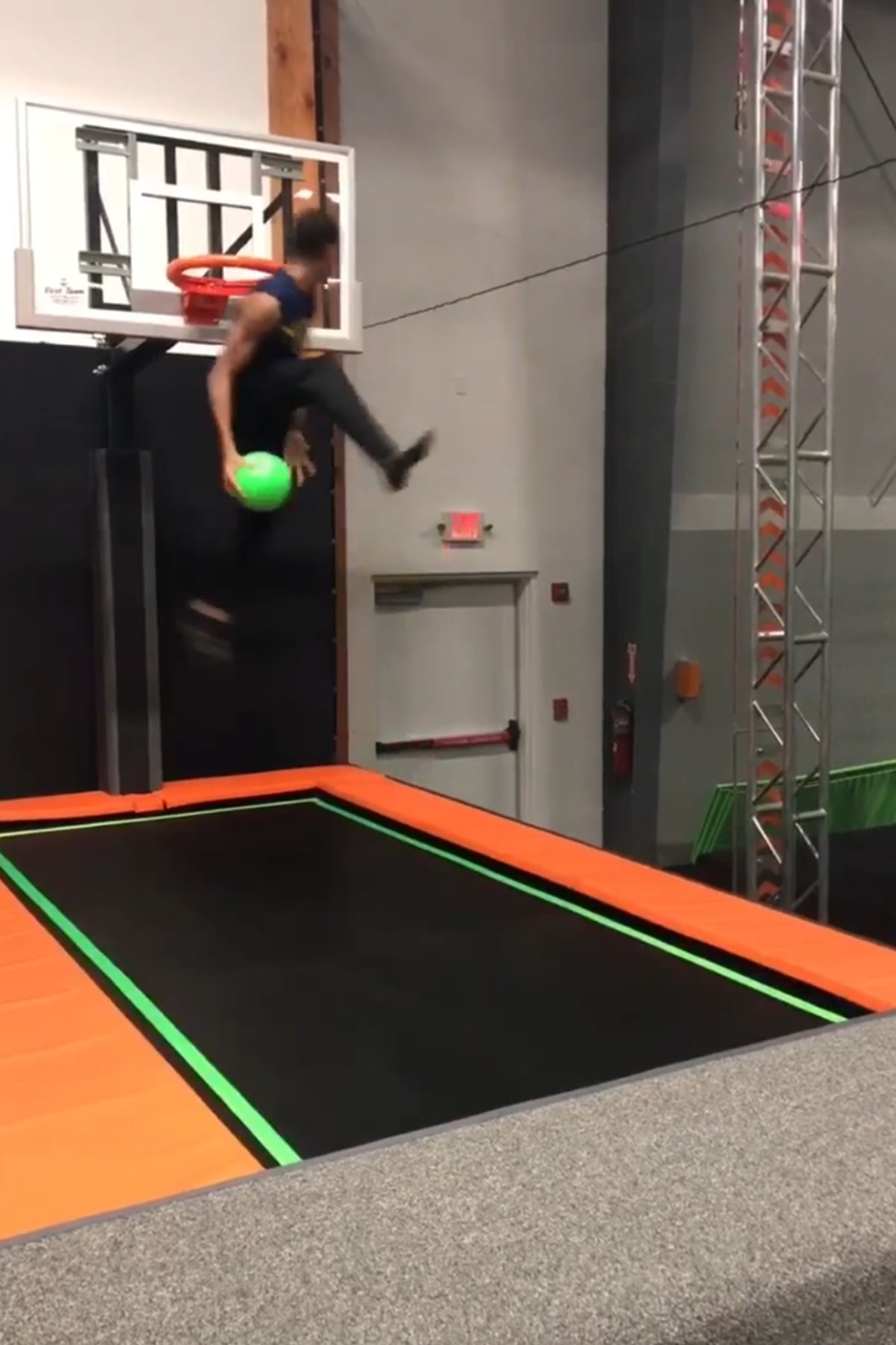 Person dunking a basketball into a hoop