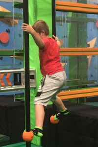 Child traversing ninja course