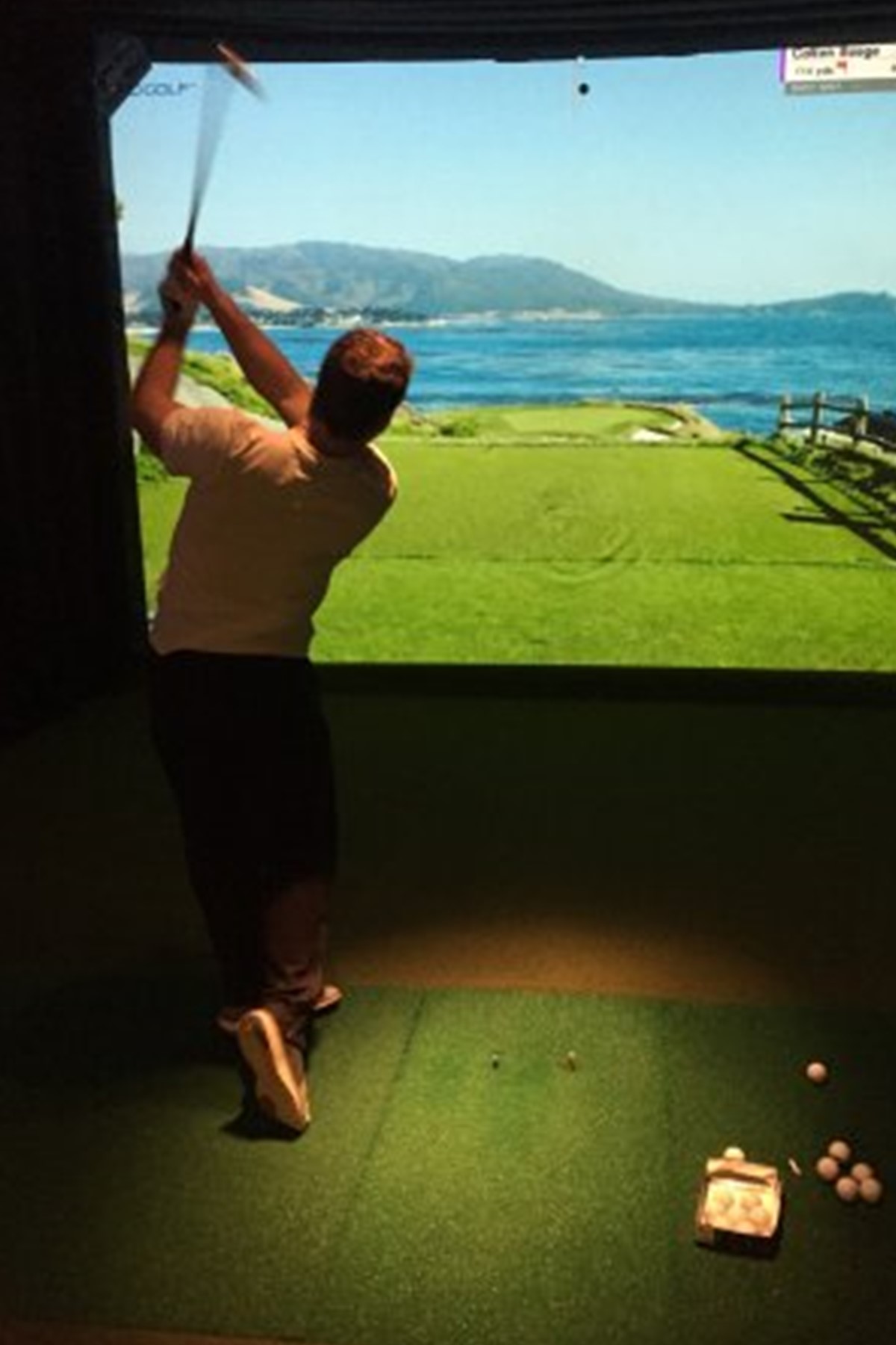 Person playing a golf simulator